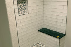 4′′ × 12′′ Ceramic tile, subway. Niche: Marble flat pebbles with brushed-nickel Schluter edge, in Aurora, Colorado