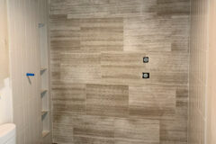 Back Wall: 18′′ × 24′′ limestone tile, random offset pattern. Side Walls & Ceiling: 4′′ × 12′′ Ceramic tile, vertical-straight pattern. Shower Floor & Curb: 12′′ × 30′′ Porcelain tile (linear drain), in Denver, Colorado