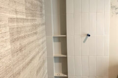 Back Wall: 18′′ × 24′′ limestone tile, random offset pattern. Side Walls: 4′′ × 12′′ Ceramic tile, vertical-straight pattern. Shower Floor: 12′′ × 30′′ Porcelain tile with linear drain, in Denver, Colorado