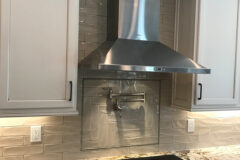 Backsplash: 3′′ × 12′′ Ceramic tile with herring bone picture frame around water faucet, in Cherry Creek, Colorado