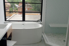 Bathroom Floor: 12′′ × 24′′ White Carrara marble, vertical straight pattern. Shower Wall: 4′′ × 4′′ Glass tile, diagonal pattern. Curb & Edge: Quartz. Floating Bench: Quartz, in Denver, Colorado