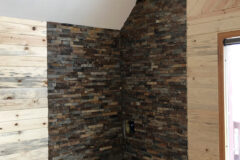 12′′ × 12′′ Granite tiles with slate-ledge (stacked stone) wall, in Conifer, Colorado