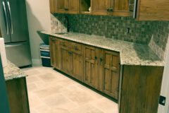 Kitchen Floor: Travertine tile, Versailles pattern. Kitchen Backsplash: 2′′ × 2′′ Travertine tile in Cherry Hills, Colorado