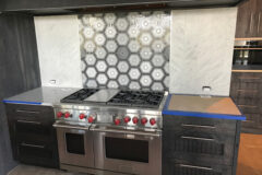 Outer Backsplash: 6′′ × 12′′ White Carrara marble, vertical offset. Middle Backsplash: Hexagon-shaped flower in Granby, Colorado