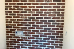 Powder Room Wall: 2′′ × 8′′ Brick, subway pattern with ½ inch grout joints. Floating toilet (tank is inside wall), in Centennial, Colorado