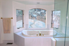 Tub Deck: 24′′ × 24′′ Porcelain tile with bullnose edge. Tub Step: White marble. Shower Bench & Curb: White marble, in Bailey, Colorado